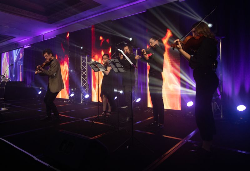 Young string players performing at a gala
